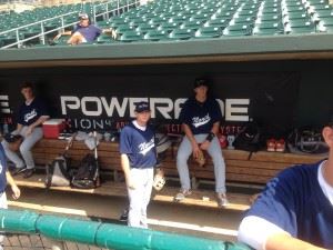 Alexandria's Dalton Cobb (L) walks through the North dugout before starting Game 1 of Tuesday's North-South all-star doubleheader in Montgomery.