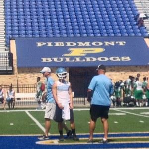 Pleasant Valley coach Jeff Davis gives a pointer to quarterback Drew Lewiski during Piedmont's 7-on-7 camp Saturday. In the main photo, Piedmont coach Steve Smith (blue shirt) watches his team intently.