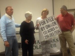 Donna Roberts (third from left) holds the For Sale sign for Indian Oaks Golf Club after he husband Lewis (left) announces his purchase of the facility.