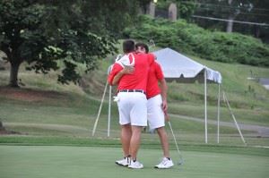 Ryan Howard reacts after making a birdie putt on the first playoff hole of the Sunny King Charity Classic on Sunday (top) and then gets a big hug from partner Lance Evans. (Photos by Kelli Howard)