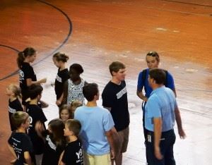 Mikey Monday (dark shirt center) talks with Blue Dolphins assistant coach Johnny Pearson (R) and teammate Elon Bush amidst well-wishers Thursday. In the main photo, Monday (L) and Bush cool down after a few laps in the YMCA pool.