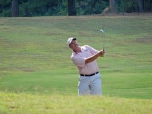 Gary Wigington hits an approach shot into a green late in his round Sunday en route to winning the Pine Hill CC Invitational.