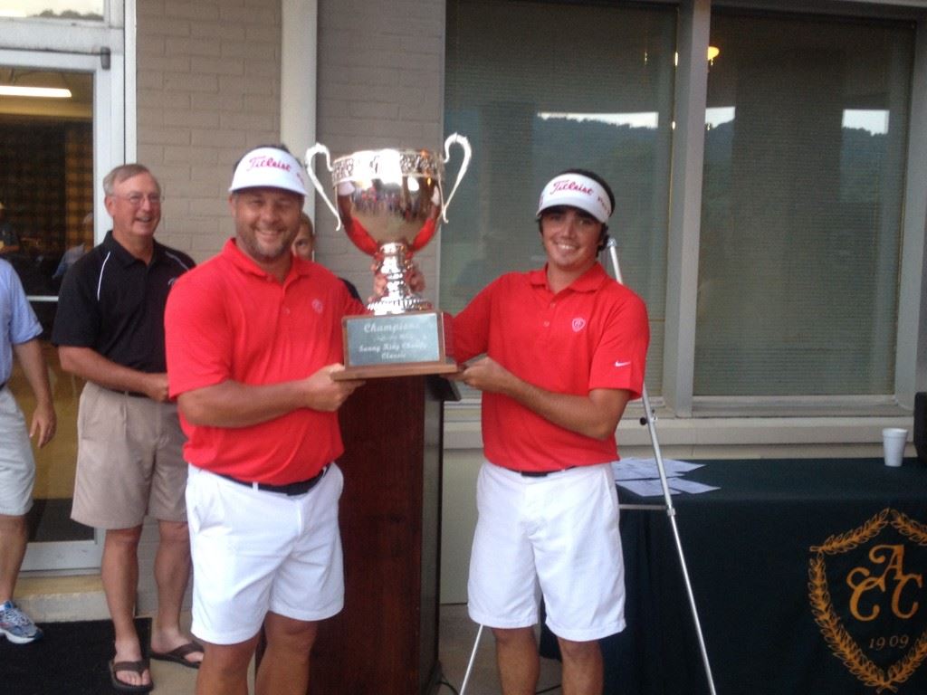 Lance Evans (L) and Ryan Howard raise the trophy after winning the 36th annual Sunny King Charity Classic in a Sunday playoff.