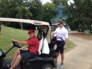 Cale Iorg (R) checks on his club before he and partner Brent Edwards head to the 10th tee at Anniston Country Club Friday. 