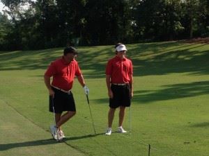 Lance Evans (L) and Ryan Howard discuss their shot in the rough at 15 Friday. They shot 56 and are two shots off the lead.