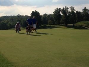 Gary Wigington and Freeman Fite (crouching left to right) line up a record-tying putt on 18 Friday with record-holders Kenny Wright and Adrian Geeting (R) watch intently.