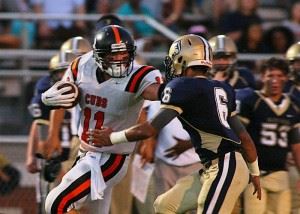 Alexandria's Austin Wells (11) tries to get away from Jacksonville's Trey Harris. In the main photo, Alexandria coach Frank Tucker talks to his charges during a timeout. (Photos by Greg McWilliams) 