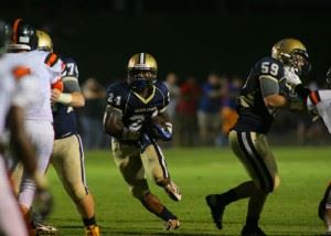 Jacksonville's new lead back, sophomore Tae Ackles (24) runs through a big hole.