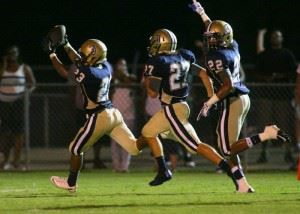 Jacksonville's Niedale Archie (23) is followed into the end zone by teammates Nick Gangwer (27) and J.J. Johnson as he returns Johnson's blocked punt that swung the game's momentum. (Photo by Greg McWilliams)