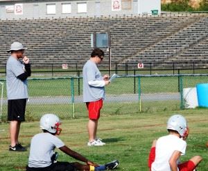 Saks coach Jonathan Miller goes over the day's schedule before sending his Wildcats through practice.