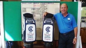 City director of golf operations Kenny Szuch stands with the embroidered staff bags that go to the winners of the Calhoun County Senior and County Championships. (Photo courtesy of Danny Waddell)