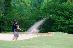 Nick Pollard blasts from a bunker during play on the back nine Sunday.