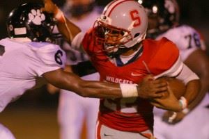 Wellborn's Robert Montgomery (6) gets ready to knock the ball loose from Saks' Calvin Figueroa in the third quarter Friday. The turnover produced Wellborn's first touchdown.