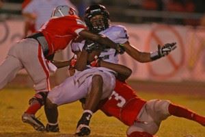 Wellborn's Landon Machristie (12) gets wrapped up by Saks' Quindarious Smith and DiQuavius McCord (3). 