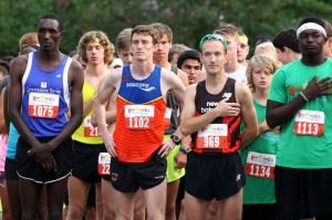 Eventual top three finishers Patrick Cheptoek (1075), Nathan Haskins (1102) and Josh Whitehead (969) pause for the National Anthem before leading the pack out on the Woodstock 5K. Enjoy all the images from Saturday's race. (Photos by Greg McWilliams) (Click to enlarge photos)