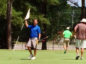 Jeremy McGatha holds the flag for the rest of the group after chipping in for eagle on No. 5 at Cane Creek GC Friday. In the other photos, Matt Rogers chips back into the fairway on No. 11 after tying for the lead on the previous hole. And Ty Cole hits out of a tough spot on No. 14. 