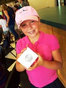 Isabel Rogers proudly displays the second-place medal she won for putting at the Drive, Chip and Putt competition Monday. In the main photo, Isabel and dad Matt commemorate the trip to the First Tee of Augusta. (Photos courtesy of Stacy McLean Rogers)