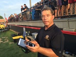 Wes Brooks, Oxford's director of football operations and baseball coach, explains the nuances of the Yellow Jackets' eye-in-the-sky game monitoring. In the main photo, he puts the technology to use.