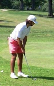 Jackson Bonner putts from off the green during the first round of the Buddy Moore Charity Classic Saturday at Anniston Municipal GC. Below, a small gallery gathers in the hospitality area behind the No. 2 green. (All photos by Henry Higginbotham)