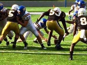 Piedmont quarterback Tyler Lusk reaches down to cover a fumbled snap near the goal line on the Bulldogs' first possession of their Champions Challenge game with Dadeville Saturday.