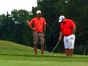 Eric Cannington (L) and Benji Turley look over their second shot into No. 12 Sunday. They birdied the hole and won a scorecard playoff for second place.