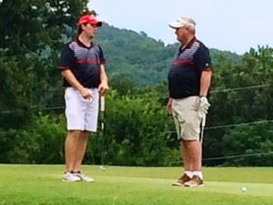 Andrew Brooks (L) and Steve Akers plot strategy on the 12th green Sunday.