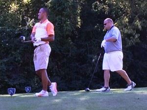 Billy Thompson (L) watches the flight of his drive off the 11th tee Wednesday during his match with Grant Hockman.