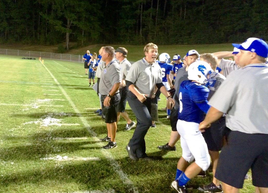 The remnants of his celebratory encounter with the water cooler lay before White Plains football coach Larry Strain in the closing minutes of Friday night's victory. In the cover photo, the players chase down Strain to take part in the tradition.