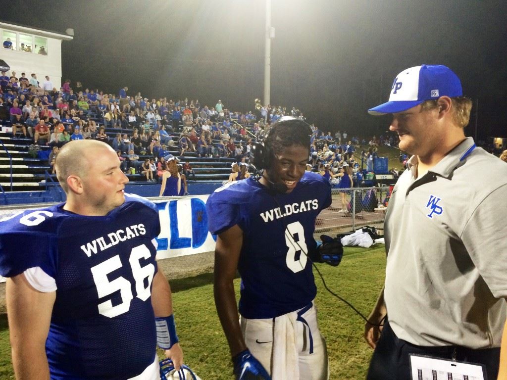 White Plains running back Lawrence Jackson (8) talks with coaches in the press box after his big game. He is flanked by teammate Zachary Gissendanner and assistant coach Blake Snider.