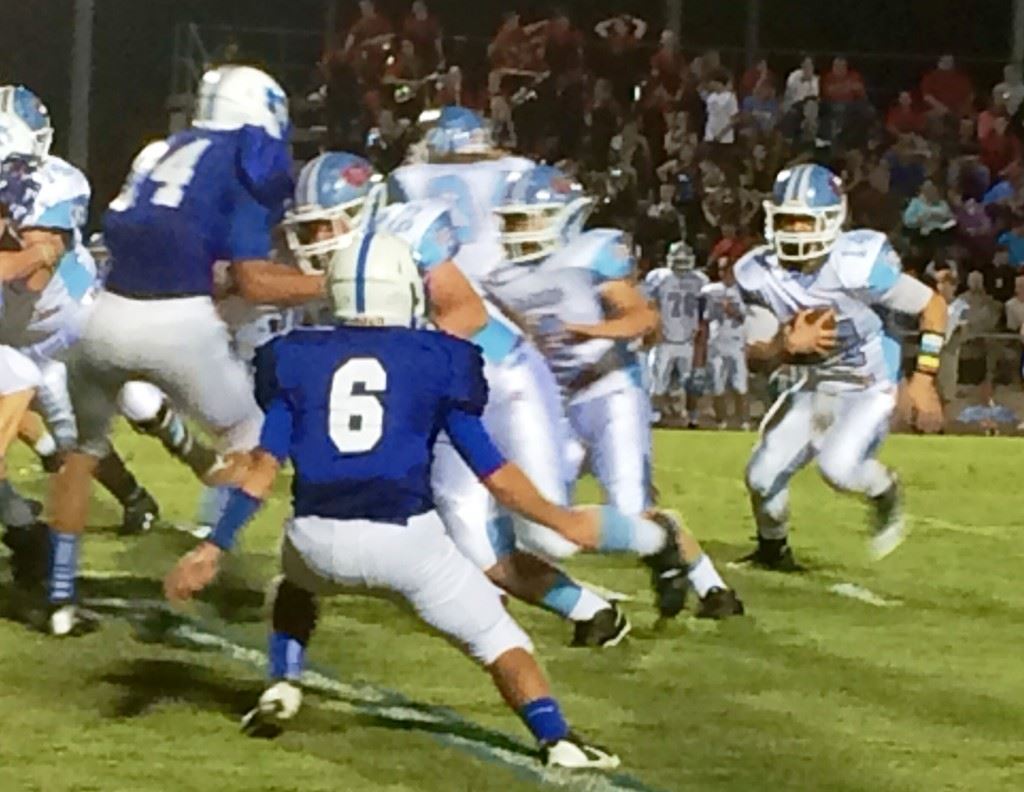 Pleasant Valley's Drew Lewiski (14) looks for running room against White Plains.