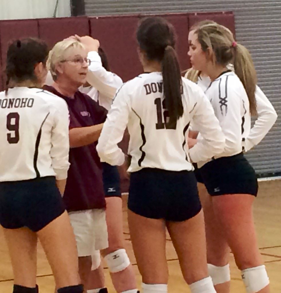 Donoho volleyball coach Janice Slay gives her team instructions during a time out in a recent win over Sacred Heart.