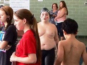 Benji Coleman makes his way along the pool deck after shaving 20 seconds off his previous best 100-meter individual medley time Saturday. In the cover photo, the Saks Middle School sixth-grader, swims a backstroke lap.