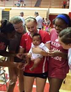 The Saks volleyball team is drawn to Wildcats senior libero Tiffany Springer and her daughter Tiana Rae.