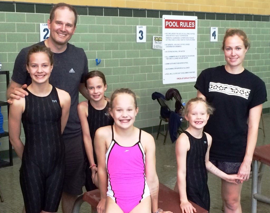 Team Tiffner. Dad Seth and mom Katie stand with (from left) Anna, Margaret, Molly and Susan. Below, Molly takes the block as mom and dad get the stopwatches ready.