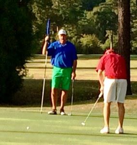 Andrew Brooks (R) sends his winning eagle putt toward the 18th hole in Thursday's championship match. In the main photo, Brooks points to his line on the bracket after winning the title.