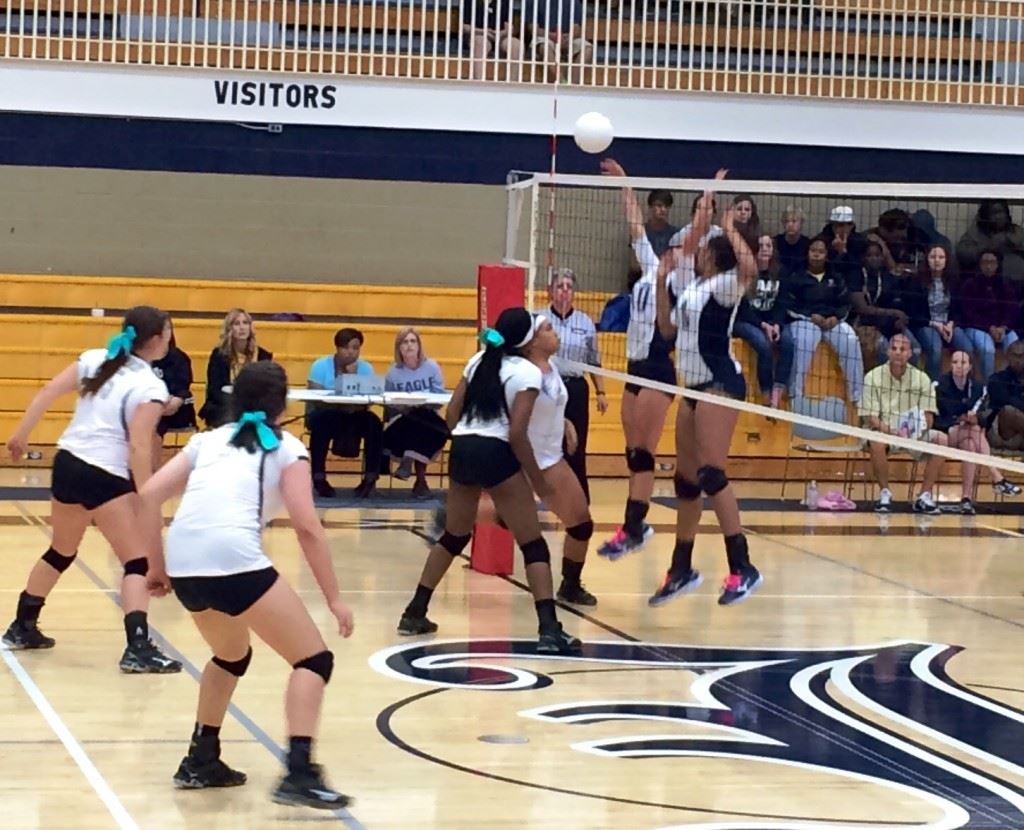 Jacksonville's play at the net was key to it winning another County Volleyball Tournament title Saturday. In the cover photo, the Golden Eagles rush the floor after beating Oxford in three sets.