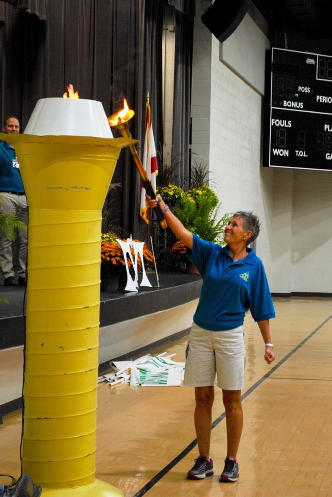 Belva Durham lights the Flame of Hope officially starting the Masters Games of Alabama in Oxford. In the cover photo (from left) Oxford Mayor Leon Smith, Oxford PARD director Don Hudson and Randy Frost of the East Alabama Planning Commission salute the nearly 600 athletes in the Games.