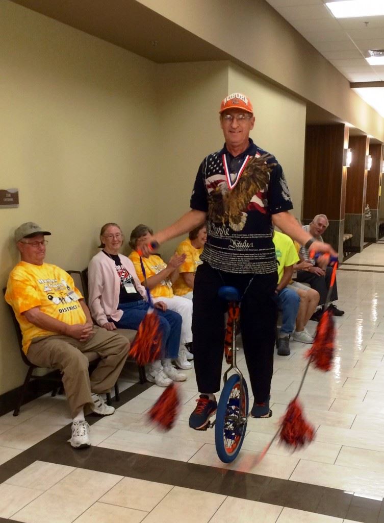 Seth Granberry of Auburn, the A-Unicycle Man, entertains the crowd in waiting Monday before the Opening Ceremonies of the Masters Games.