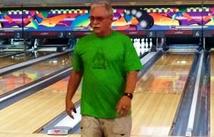 Terry Brantley returns to his seat after another strike at the Anniston Bowling Center. In the cover photo, David Atkinson strikes again. Both bowlers threw games in the 220s Wednesday.