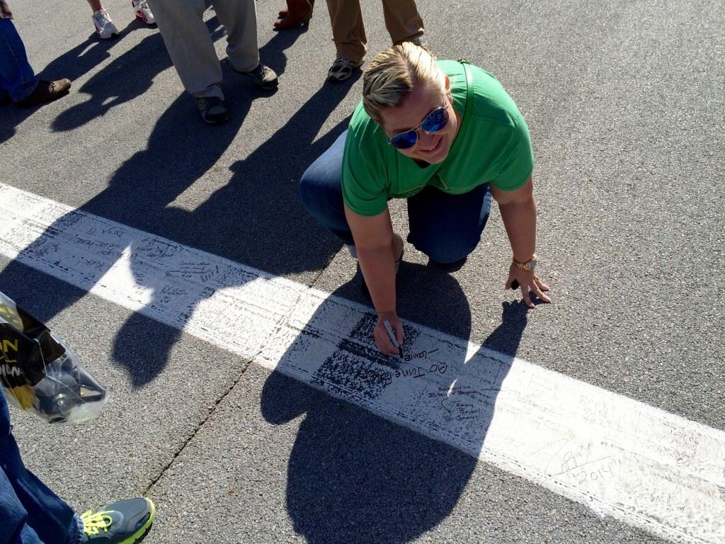 Lauren Sherrill, a Dale Earnhardt Jr. fan from Pensacola, Fla., extends well wishes to her favorite driver on pit road Sunday. Earnhardt, as expected, received the biggest ovation during driver introductions. 