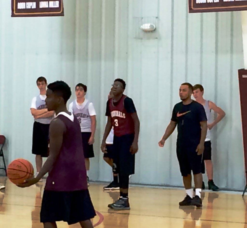 Sacred Heart coach Ralph Graves (R) puts his basketball team through practice Sunday.