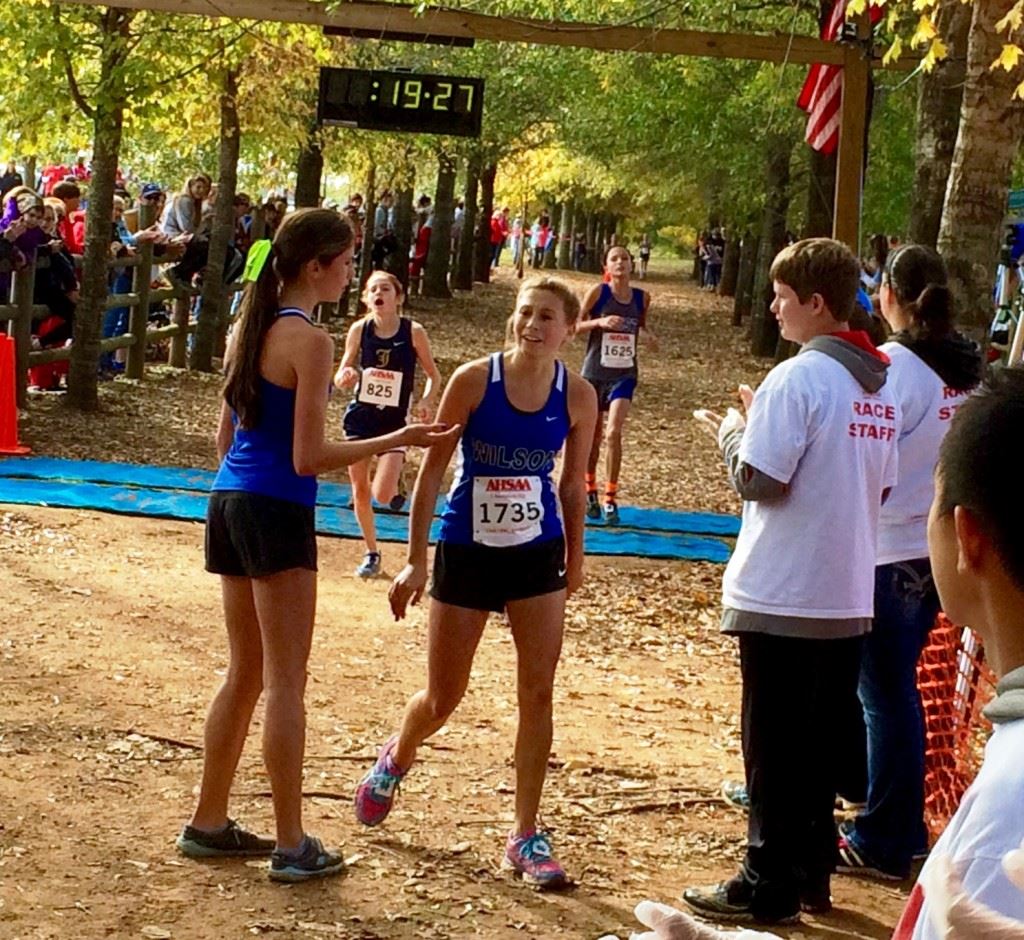 Jacksonville's Rebecca Hearn (825) beats West Limestone's Cassidy Winter to the line for fifth place in the Class 4A girls race. Then (below) she gives big brother Braden a big hug for winning his dare.