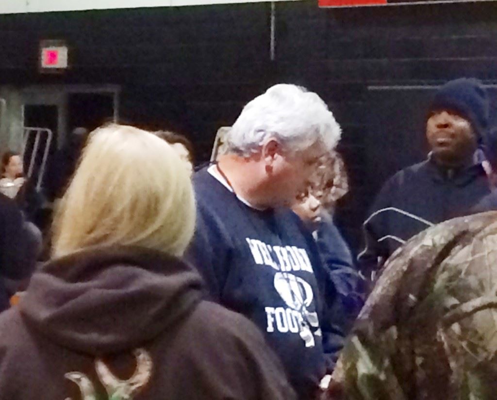 Wellborn football coach Jeff Smith visits with supporters after he and principal Christopher Hayes explained the fallout of the Oakman game to the community Monday night.