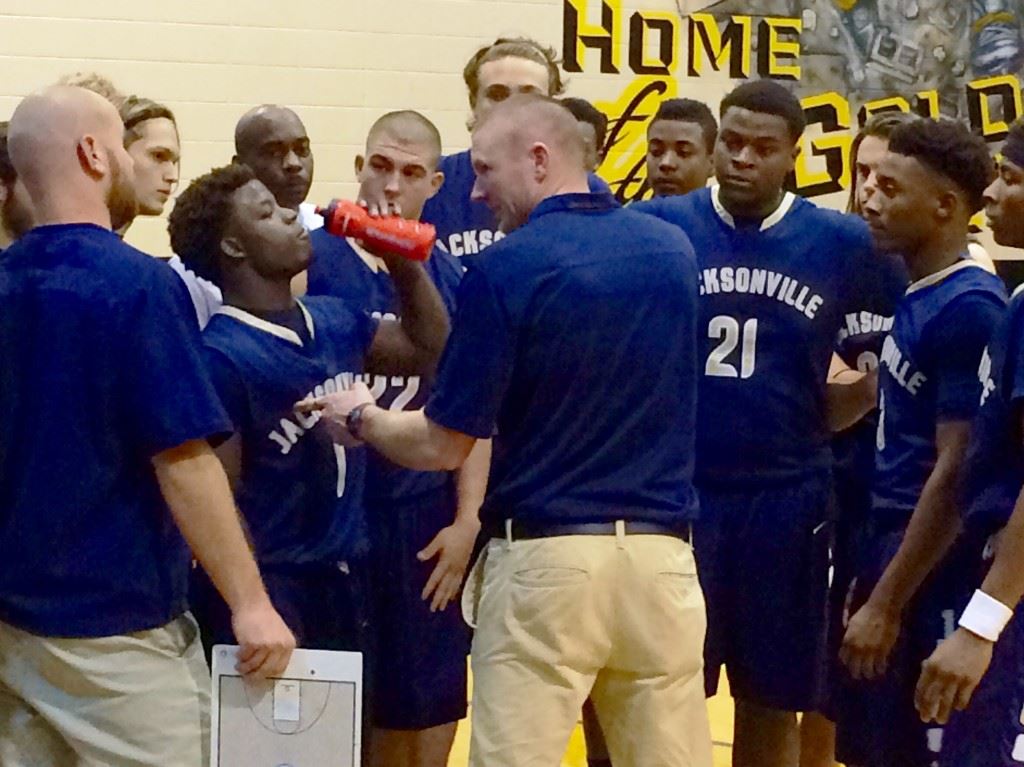 Jacksonville coach Ryan Chambless makes a point to Sid Thurmond (1) during a time out in the second half of their game with Lincoln Wednesday. Thurmond's two free throws with 8.8 seconds left sealed the Golden Eagles' victory.