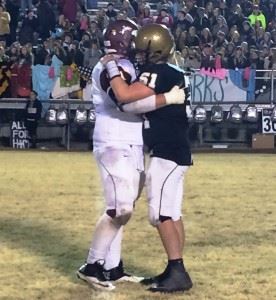 Madison Academy lineman William Dye respectfully embraces Glencoe's Ty Minshew (51) after Friday night's hard-fought 3A state semifinal game.