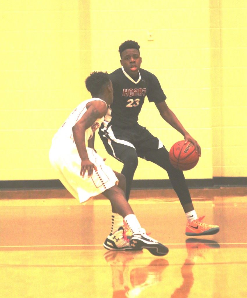 Sacred Heart's Kevion Nolan (23) considers taking his Gadsden City defender to the basket or pulling up for one of his six 3-pointers. (Photo by Kristen Stringer/Krisp Pics Photography)