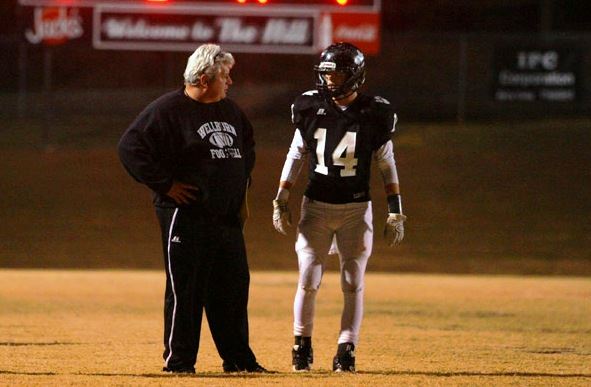 Wellborn coach Jeff Smith (L) talks things over with Jake Thrasher during the fourth quarter of Friday night's playoff victory. (Photo by Greg McWilliams)
