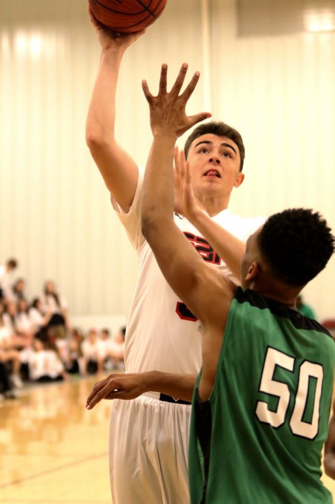 Sam Miller puts up a shot over Leeds' Jeffrey Nolan in Sacred Heart's 69-57 victory. (Photo by Kristen Stringer/Krisp Pics Photography)