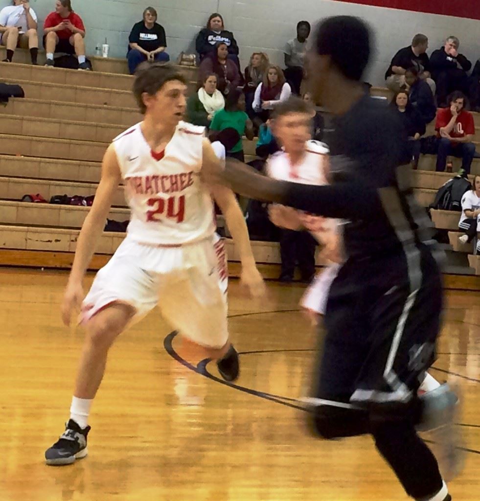 Ohatchee's Austin Tucker (24) considers doubling back for a loose ball; his two free throws with 2.4 seconds left won the game. On the cover, Wellborn's Corri Tignor (4) goes high for a potential rebound. 