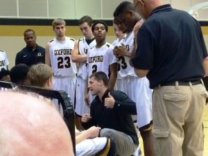 Oxford boys coach Joel Van Meter gives his team instructions during a timeout. On the cover, Oxford girls coach Tonya Peoples is doing the same.